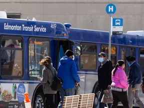 Passengers embark and disembark on buses at the Mill Woods Transit Centre.