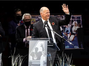 Former Edmonton Oilers defenceman Kevin Lowe waves during a jersey retirement ceremony on the ice at Rogers Place in Edmonton, on Friday, Nov. 5, 2021.