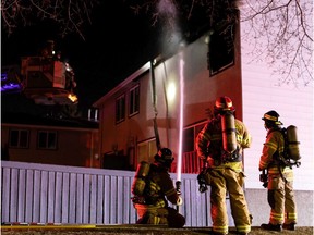 Edmonton Fire Rescue Service firefighters extinguish a fire at condo at Lee Ridge Road and Millbourne Road East in Mill Woods, on Wednesday night, Nov. 10, 2021.