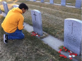 Cam Tait's grandson Nick Davis put poppies on the headstones of his grandparents’ graves on Thursday.