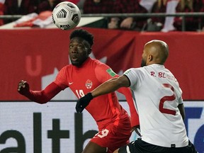 Team Canada's Alphonso Davies, left, and Team Costa Rica's Ricardo Blanco battle for the ball during a FIFA 2022 World Cup qualifier soccer match held at Commonwealth Stadium in Edmonton on Friday, Nov. 12, 2021.