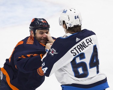 Edmonton Oilers Zack Kassian (44) and Winnipeg Jets Logan Stanley (64) fight during first period NHL action on Thursday, Nov. 18, 2021 in Edmonton.