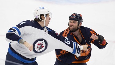 Edmonton Oilers Zack Kassian (44) and Winnipeg Jets Logan Stanley (64) fight during first period NHL action on Thursday, Nov. 18, 2021 in Edmonton.