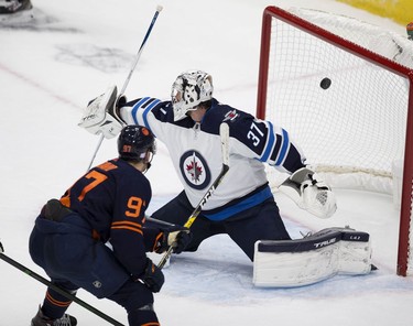 Edmonton Oilers Connor McDavid (97) scores on Winnipeg Jets Connor Hellebuyck (37) during third period NHL action on Thursday, Nov. 18, 2021 in Edmonton.