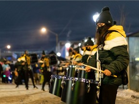 The Edmonton Elks EE Force Hype Team and Drumline perform on 124 Street during the All is Bright Festival in Edmonton on Saturday, Nov. 20, 2021.