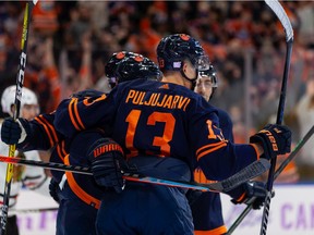 Edmonton Oilers' Connor McDavid (97) celebrates a goal with teammates on Chicago Blackhawks' goaltender Kevin Lankinen (32) during first period NHL action at Rogers Place in Edmonton, on Saturday, Nov. 20, 2021.