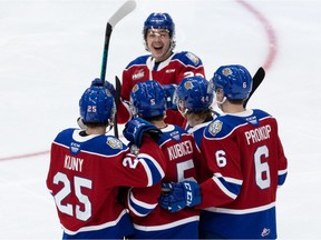 Edmonton Oil Kings' Simon Kubicek (5) celebrates a goal with teammates on Calgary Hitmen goaltender Brayden Peters during second period WHL action at Rogers Place in Edmonton on Nov. 21, 2021.