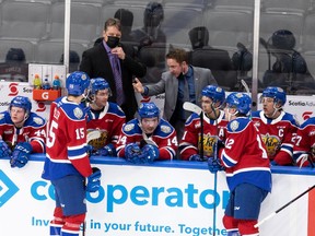 Edmonton Oil Kings head coach Brad Lauer (left) and assistant coach Luke Pierce (centre) speak with their team as they play the Calgary Hitmen during second period WHL action at Rogers Place in Edmonton, on Sunday, Nov. 21, 2021. Photo by Ian Kucerak