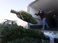 Caleb Weiss unloads one of the 735 trees that  Greenland Garden Centre received on Wednesday, Nov. 24, 2021 in Sherwood Park . While there has been wide-spread fears of a Christmas tree shortage because of the Pandemic coupled with floods in B.C.,Greenland Garden Centre's longstanding relationship with a tree vendor in Oregon has helped avoid any supply shortages this season as they will have enough to meet the holiday season demand.   Greg Southam-Postmedia