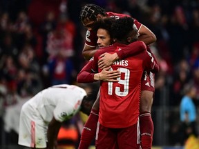 Bayern Munich's German midfielder Leroy Sane (C) celebrates scoring his team's third goal with Bayern Munich's German midfielder Serge Gnabry (Back) and Bayern Munich's Canadian midfielder Alphonso Davies during the UEFA Champions League group E football match  Bayern Munich v Benfica Lisbon on November 2, 2021 in Munich, Germany.