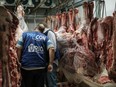 The staff of Rio de Janeiro state's consumer protection agency, PROCON, inspect meat products in the cold storage room at a supermarket in Rio de Janeiro, Brazil, on March 24, 2017.