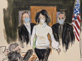 Ghislaine Maxwell enters the courtroom escorted by U.S. Marshalls at the start of her trial, Monday, Nov. 29, 2021, in New York.