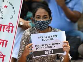 Activists of Student Federation of India (SFI) and All India Democratic Women's Association (AIDWA) hold placards during a protest against the alleged rape and murder of a nine-year-old girl, in New Delhi on August 4, 2021.