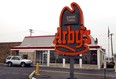 An SUV sits at the pick-up window of an Arby's restaurant in Des Plaines, Illinois.