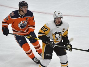 Edmonton Oilers captain Connor McDavid (97) and Pittsburgh Penguins captain Sidney Crosby (87) square off at Rogers Place in Edmonton on Oct. 23, 2018.