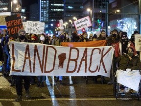 Demonstrators march down Jasper Avenue towards the Alberta Legislature, as they rally against the use of legal injunctions, police forces, and criminalizing state tactics against the Wet'suwet'en Nation in their fight against the Coastal Gaslink Pipeline, in Edmonton Monday Nov. 22, 2021. Photo by David Bloom