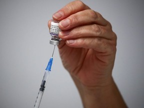 A medical worker prepares a dose of the "Comirnaty" Pfizer-BioNTech COVID-19 vaccine at a coronavirus disease (COVID-19) vaccination center in Madrid, Spain, November 24, 2021.