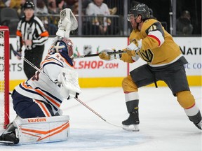 Edmonton Oilers goaltender Mikko Koskinen (19) makes a glove save as Vegas Golden Knights center Jonathan Marchessault (81) looks to deflect the puck during the first period at T-Mobile Arena.