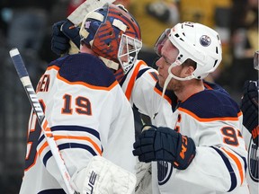 Edmonton Oilers' Connor McDavid (97) congratulates goaltender Mikko Koskinen (19) after the Oilers defeated the Vegas Golden Knights 3-2 at T-Mobile Arena.