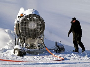 Geva Betser, operations manager at the Edmonton Ski Club, makes snow while the sun shines on Wednesday November 24, 2021. The ski hill, located near downtown Edmonton, is now open for the season. (PHOTO BY LARRY WONG/POSTMEDIA)