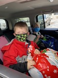 Little Santas Rylan and Graycen prepare to take home a gift they picked out for their mother Lennea at Kaleo Collective's gift tent last December.