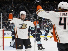 Mason McTavish (No. 37) of the Anaheim Ducks celebrates his goal with Max Comtois (No. 44) against the Seattle Kraken during the first period on November 11, 2021 at Climate Pledge Arena in Seattle, Washington.