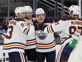 Leon Draisaitl (29) of the Edmonton Oilers celebrates his power-play goal with teammates against the Seattle Kraken while playing in his 500th NHL game, at Climate Pledge Arena on Dec. 03, 2021, in Seattle.