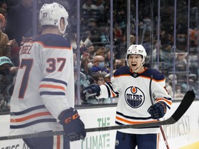 Warren Foegele (37) celebrates his goal with Kailer Yamamoto (56) of the Edmonton Oilers against the Seattle Kraken at Climate Pledge Arena on Dec. 18, 2021, in Seattle.