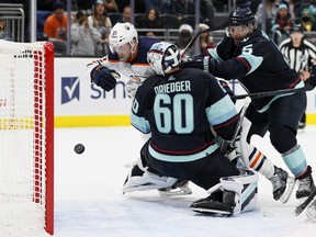 Warren Foegele #37 of the Edmonton Oilers scores against Chris Driedger #60 of the Seattle Kraken during the third period at Climate Pledge Arena on December 18, 2021 in Seattle, Wash.