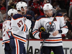 Connor McDavid (97) and Leon Draisaitl (29) of the Edmonton Oilers talk during a video review in the third period against the New Jersey Devils at Prudential Center on December 31, 2021 in Newark, New Jersey.