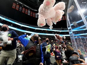 Fans throw teddy bears onto the ice following a first period goal by the newest member of teh Edmonton Oil Kings, Graydon Gotaas, during the 14th annual Teddy Bear Toss in Edmonton on Saturday Dec. 4, 2021.