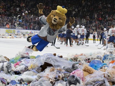 The Edmonton Oil Kings mascot, Louie the Lion, jumps into a pile of a teddy bears during the Oil Kings' 14th annual Teddy Bear Toss in Edmonton on Saturday Dec. 4, 2021.