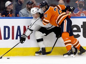 The Edmonton Oilers' Darnell Nurse (25) battles the Los Angeles Kings' Dustin Brown (23) at Rogers Place in Edmonton on Sunday, Dec. 5, 2021.
