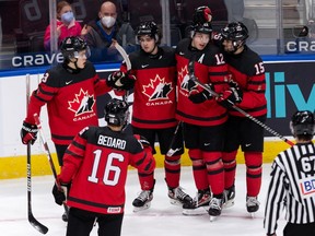 Team Canada’s Lukas Cormier (6) celebrates a goal with teammates on Team Russia’s goalie Yaroslav Askarov (30) during first period of IIHF World Junior Championship exhibition play at Rogers Place in Edmonton, on Thursday, Dec. 23, 2021.