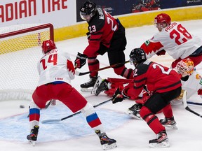 Team Canada’s Mason McTavish (23) scores on Team Russia goalie Yaroslav Askarov (30) in their IIHF world junior championship exhibition game at Rogers Place in Edmonton on Thursday, Dec. 23, 2021.