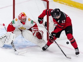 Team Canada’s Jake Neighbours (12) chases a puck in front of Team Russia’s goalie Yegor Guskov (29) during third period of IIHF World Junior Championship exhibition play at Rogers Place in Edmonton, on Thursday, Dec. 23, 2021.