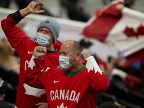 Team Canada fans watch the game against Team Austria during the IIHF world junior championship in Edmonton on Tuesday, Dec. 28, 2021.