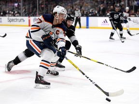 Connor McDavid (97) of the Edmonton Oilers breaks in on Derek Forbort (24) of the Los Angeles Kings in a 4-2 Oilers' win at Staples Center on Feb. 23, 2020, in Los Angeles.