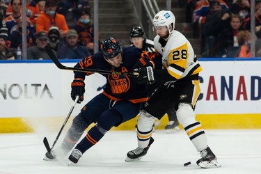 Edmonton Oilers' Leon Draisaitl (29) battles Pittsburgh Penguins' Marcus Pettersson (28) during first period NHL action at Rogers Place in Edmonton, on Wednesday, Dec. 1, 2021.
