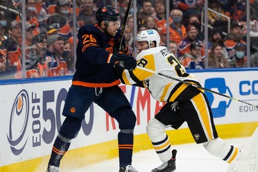 Edmonton Oilers' Leon Draisaitl (29) battles Pittsburgh Penguins' Brian Dumoulin (8) during first period NHL action at Rogers Place in Edmonton, on Wednesday, Dec. 1, 2021.
