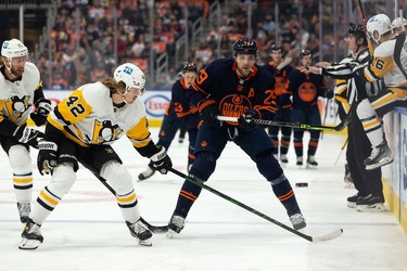 Edmonton Oilers' Leon Draisaitl (29) battles Pittsburgh Penguins' Kasperi Kapanen (42) during first period NHL action at Rogers Place in Edmonton, on Wednesday, Dec. 1, 2021.