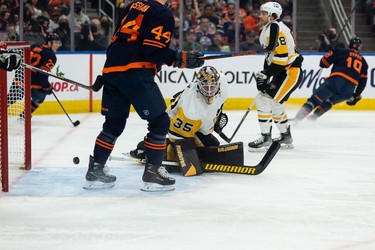 Edmonton Oilers' Zach Hyman (18) scores a goal on Pittsburgh Penguins' goaltender Tristan Jarry (35)  during first period NHL action at Rogers Place in Edmonton, on Wednesday, Dec. 1, 2021.