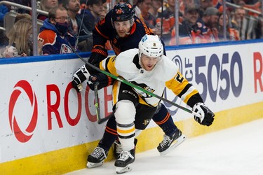 Edmonton Oilers' Leon Draisaitl (29) battles Pittsburgh Penguins' Chad Ruhwedel (2) during first period NHL action at Rogers Place in Edmonton, on Wednesday, Dec. 1, 2021.