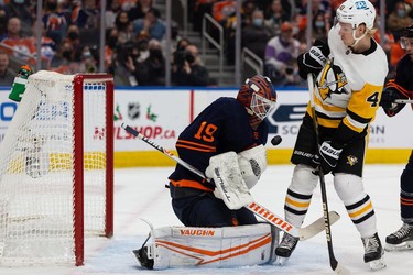 Edmonton Oilers' goaltender Mikko Koskinen (19) makes a save in front of Pittsburgh Penguins' Danton Heinen (43) during second period NHL action at Rogers Place in Edmonton, on Wednesday, Dec. 1, 2021.