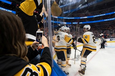 Pittsburgh Penguins' Teddy Blueger (53) celebrates a goal on Edmonton Oilers' goaltender Mikko Koskinen (19) with teammates during second period NHL action at Rogers Place in Edmonton, on Wednesday, Dec. 1, 2021.