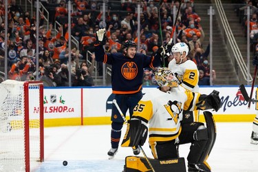 Edmonton Oilers' Zach Hyman (18) celebrates Kailer Yamamoto's (56) goal on Pittsburgh Penguins' goaltender Tristan Jarry (35) during third period NHL action at Rogers Place in Edmonton, on Wednesday, Dec. 1, 2021.