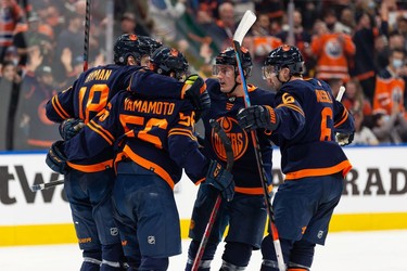 Edmonton Oilers' Kailer Yamamoto (56) celebrates a goal with teammates on Pittsburgh Penguins' goaltender Tristan Jarry (35) during third period NHL action at Rogers Place in Edmonton, on Wednesday, Dec. 1, 2021.