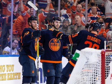 Edmonton Oilers' Evan Bouchard (75) celebrates a goal on Pittsburgh Penguins' goaltender Tristan Jarry (35) with teammates during third period NHL action at Rogers Place in Edmonton, on Wednesday, Dec. 1, 2021.