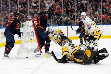 Edmonton Oilers' Zach Hyman (18) scores on Pittsburgh Penguins' goaltender Tristan Jarry (35) during third period NHL action at Rogers Place in Edmonton, on Wednesday, Dec. 1, 2021. The goal, which was celebrated as a hattrick, was ruled off.
