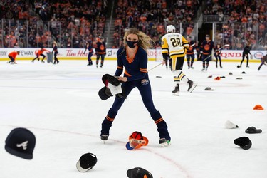 Fans throw their hats on the ice after a goal, which was ruled offside, by Edmonton Oilers' Zach Hyman (18) on Pittsburgh Penguins' goaltender Tristan Jarry (35) during third period NHL action at Rogers Place in Edmonton, on Wednesday, Dec. 1, 2021.